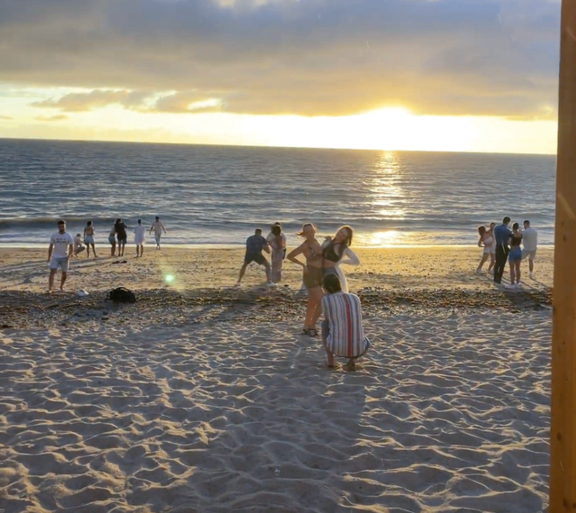 Dancers on the beach at sunset during Bachata Week Cádiz